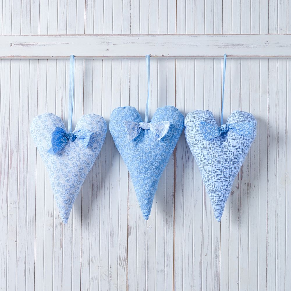 Hearts hanging on wooden background art print by Assaf Frank for $57.95 CAD