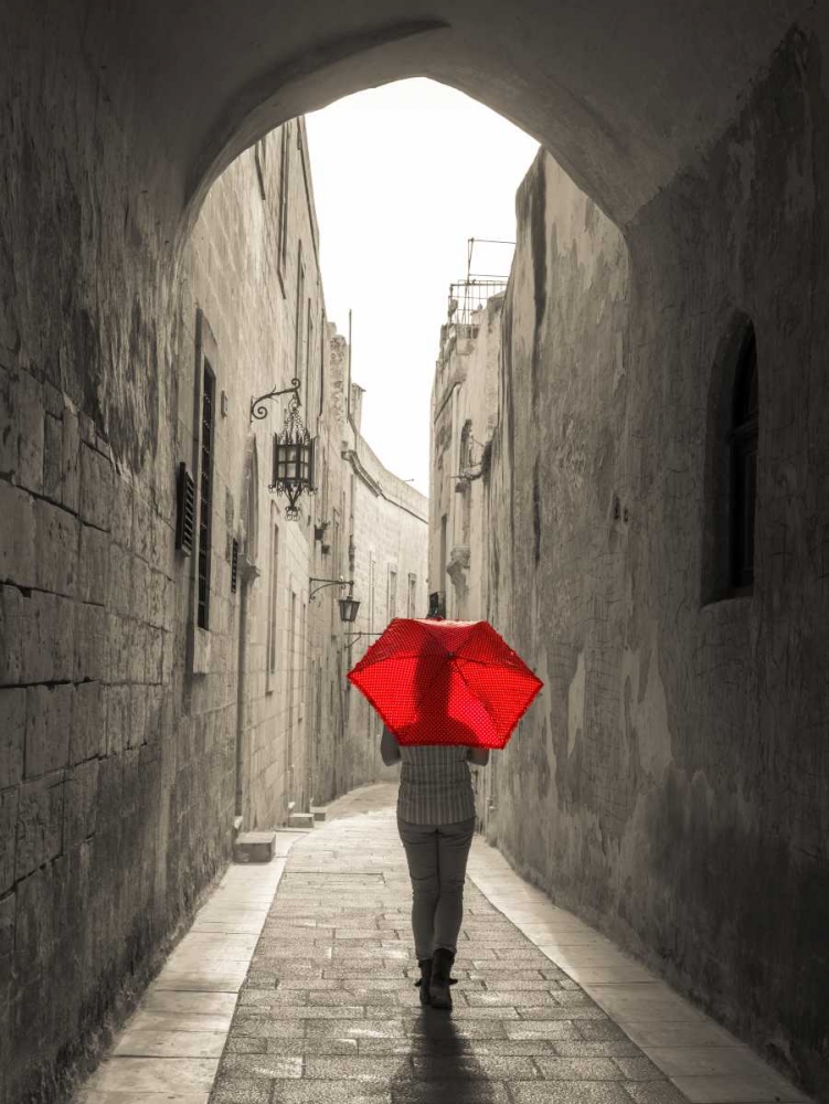 Tourist with umbrella walking through narrow street in Mdina, Malta art print by Assaf Frank for $57.95 CAD