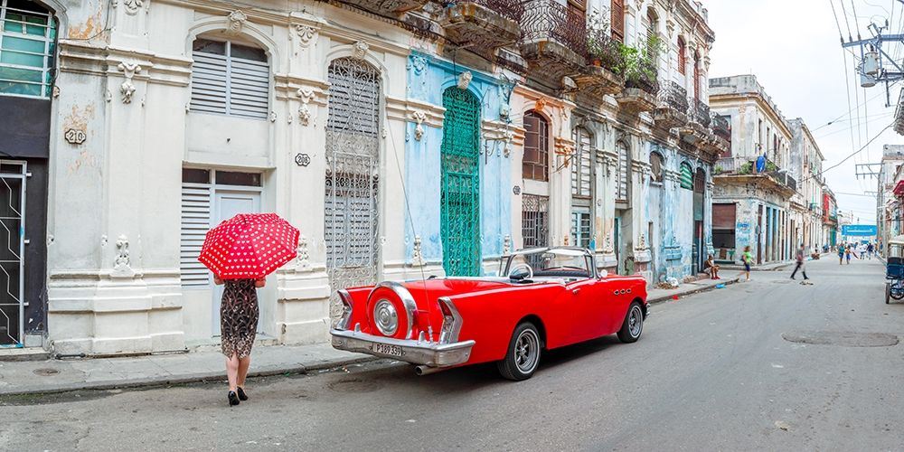 Woman with red umbrella by a vintage car on the street of Havana, Cuba, FTBR 1851 art print by Assaf Frank for $57.95 CAD