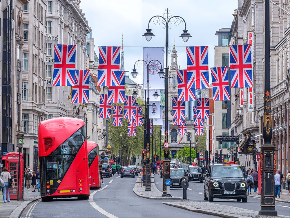 Double decker buses and taxis on street of London with British flags art print by Assaf Frank for $57.95 CAD