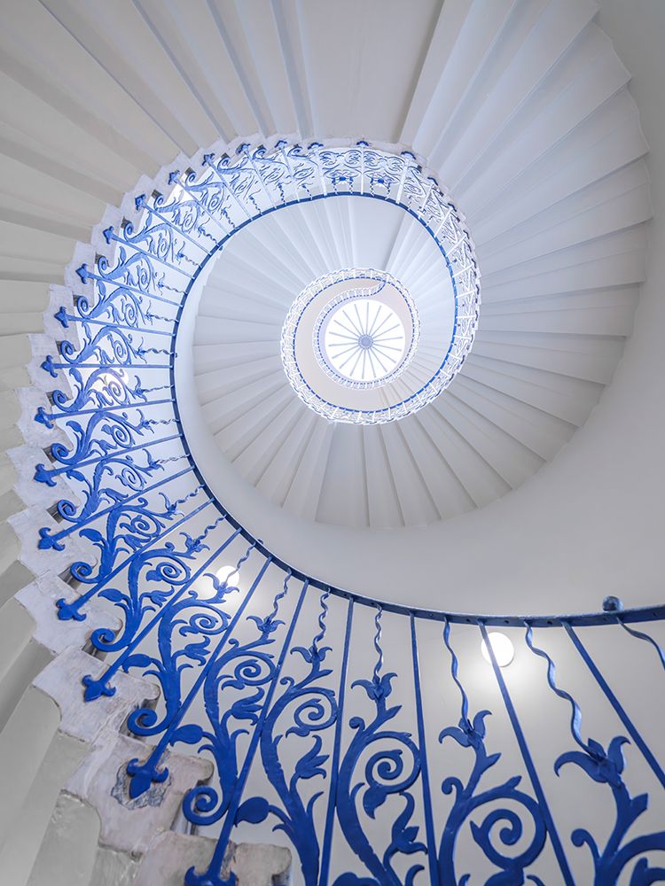 Looking up at spiral staircase with Blue railing art print by Assaf Frank for $57.95 CAD