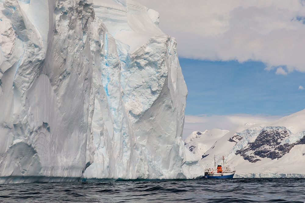 Southern Ocean, Antarctica. Huge weathered tabular icebergs appear to loom over a ship. art print by Ellen B. Goff for $57.95 CAD