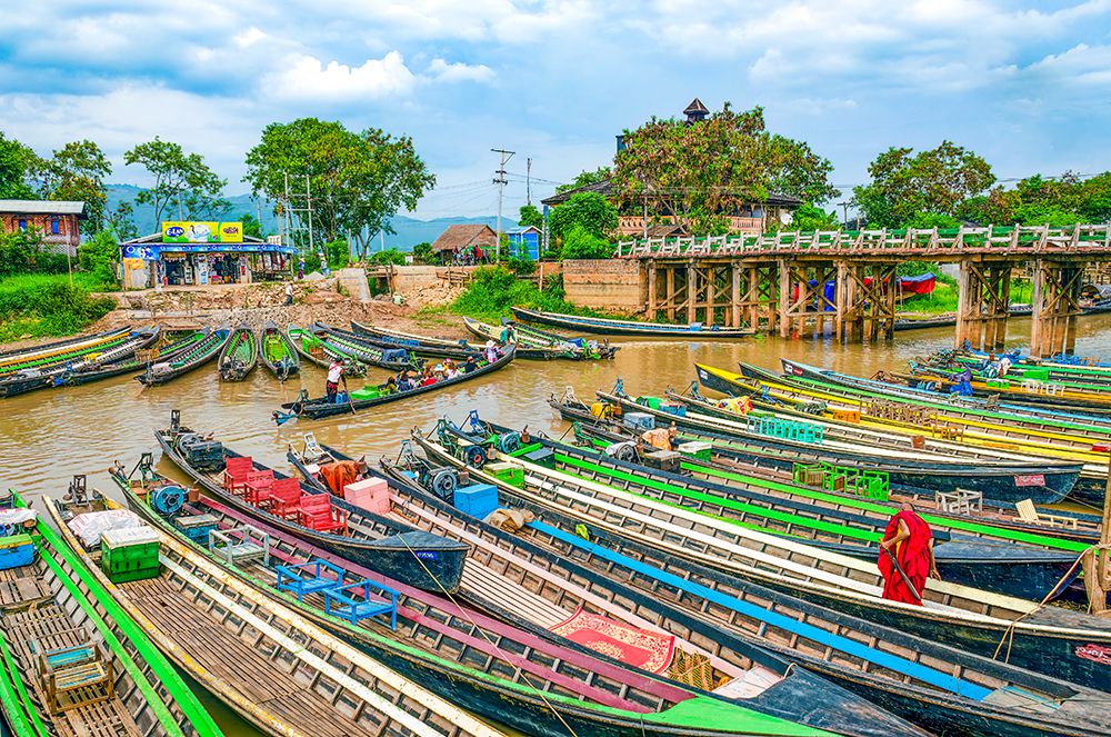 Nyaungshwe, Myanmar, Asia, Buddhist monk in red robe making his way onto long boat in canal. art print by Murray McCallum for $57.95 CAD