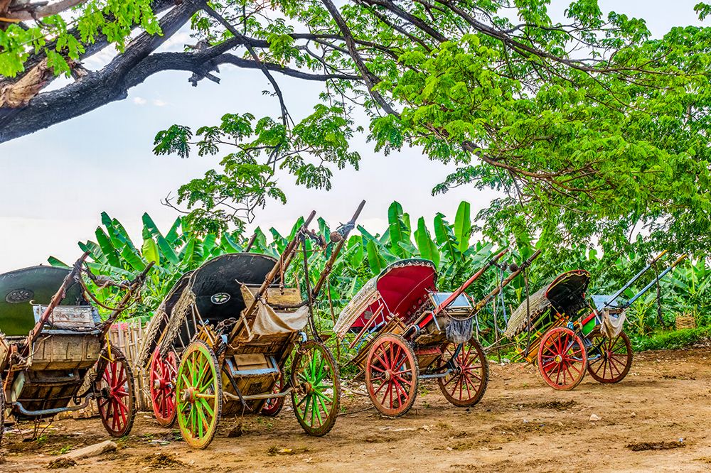 Riverside, Myanmar. rickshaws along the riverside waiting for customers arriving from the ferry. art print by Murray McCallum for $57.95 CAD