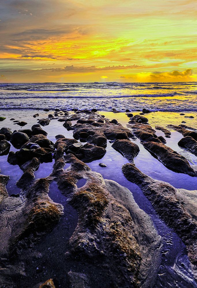 The golden setting sun reflects a gold glow on the beach at Pererenan Beach-Bali-Indonesia art print by Greg Johnston for $57.95 CAD