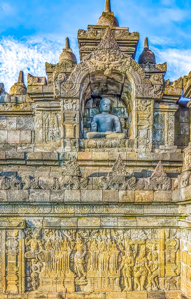 Java, Indonesia. One of the original 504 statues of Buddha in a carved niche of Borobudur Temple. art print by Murray McCallum for $57.95 CAD