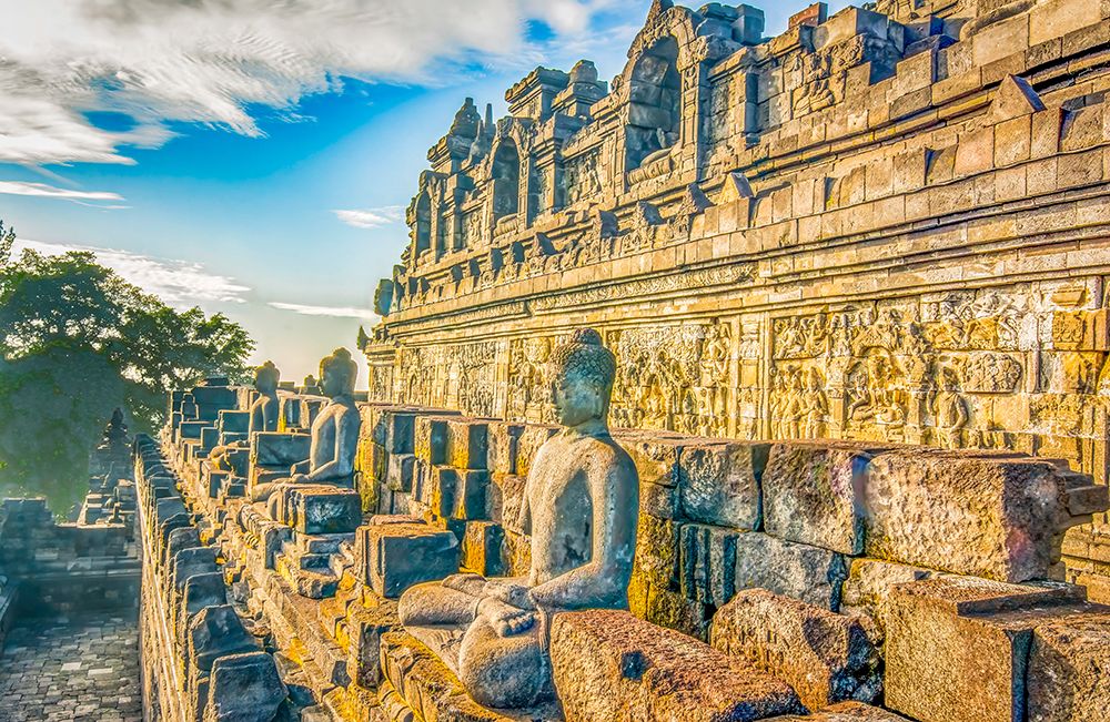 Java, Indonesia. Some of the original 504 statues of Buddha on a ledge of Borobudur Temple. art print by Murray McCallum for $57.95 CAD