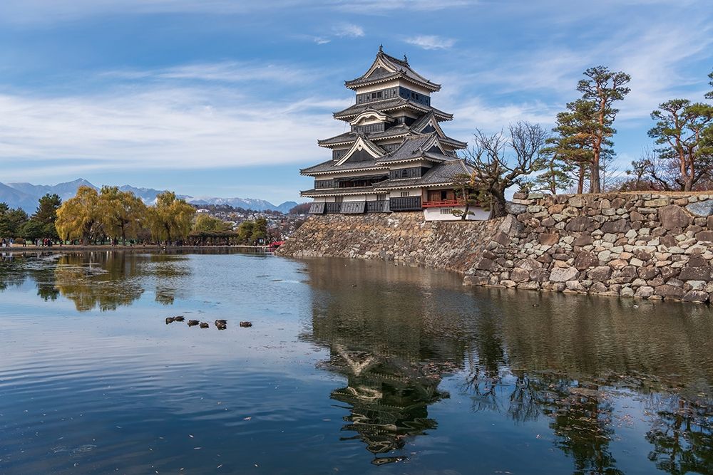 The reflection of the Matsumoto Castle and the castle against the mountain backdrop in Japan art print by Sheila Haddad for $57.95 CAD