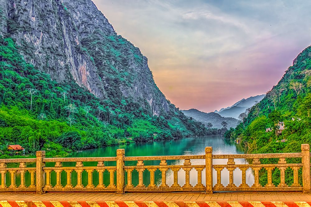 Mekong River, Laos. Landscape view of sunset from a bridge over the Mekong River. art print by Murray McCallum for $57.95 CAD