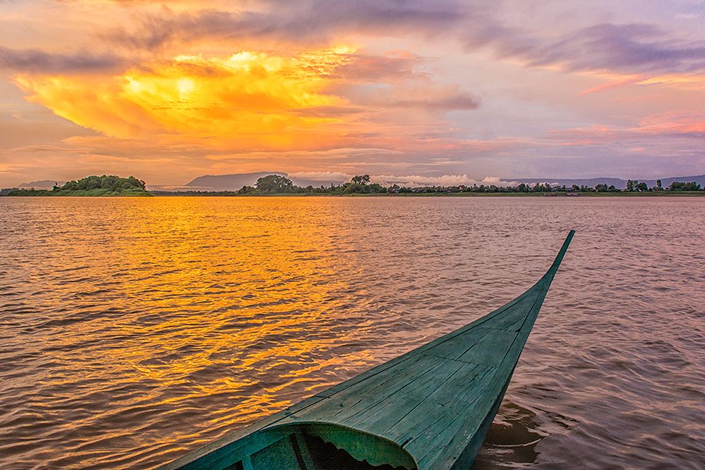 Irrawaddy River, Laos. Wide angle landscape view of Irrawaddy River at sunset from an outrigger. art print by Murray McCallum for $57.95 CAD