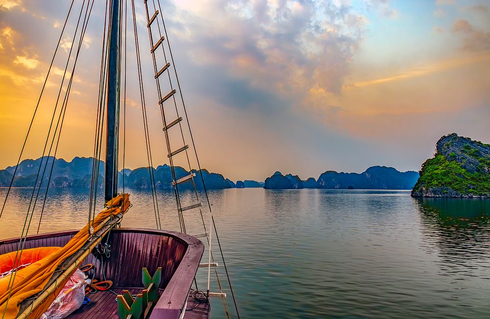 Ha Long Bay, Vietnam. tourist boat at sunset among the limestone karsts and islets. art print by Murray McCallum for $57.95 CAD