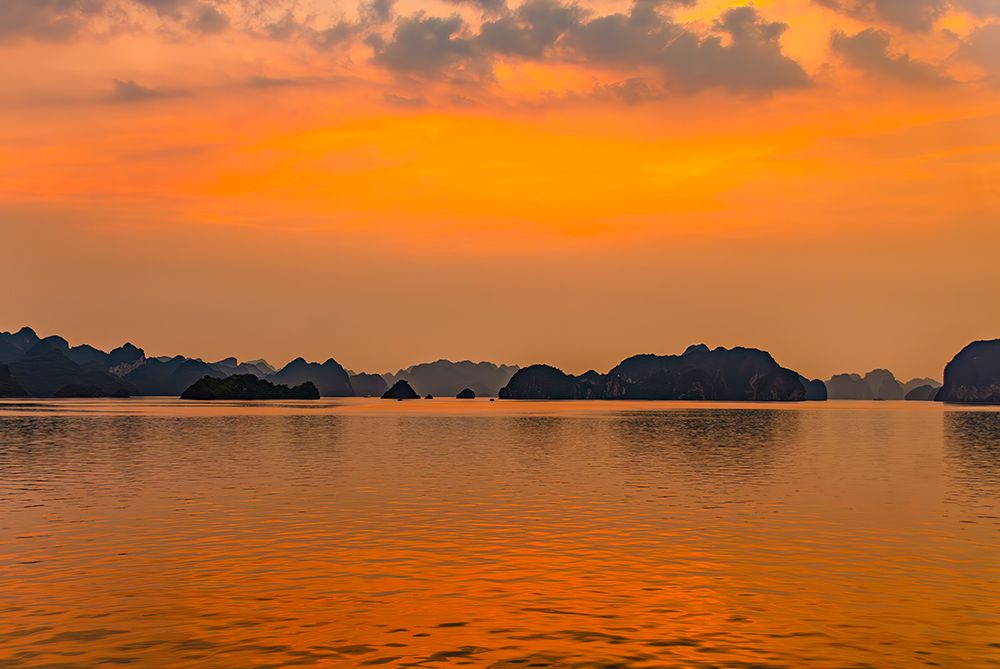 Ha Long Bay, Vietnam. Fishing boats at sunset among the limestone karsts and islets, UNESCO Site. art print by Murray McCallum for $57.95 CAD