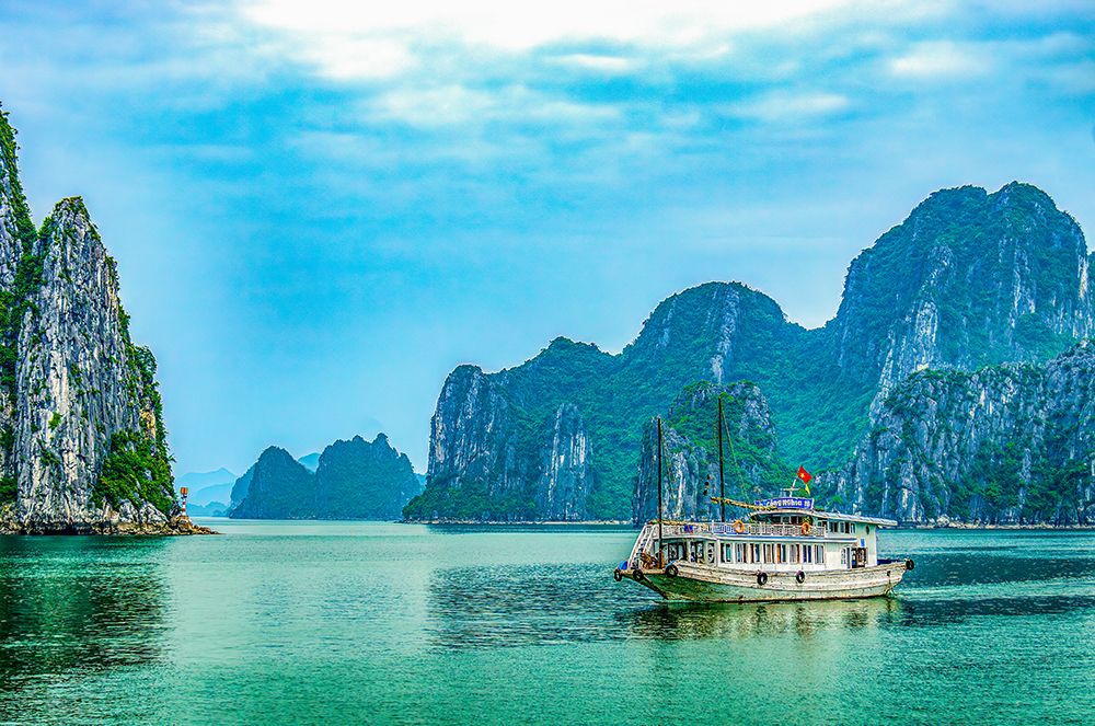 Ha Long Bay, Vietnam. Tourist boat among the limestone karsts and islets of the UNESCO Site. art print by Murray McCallum for $57.95 CAD