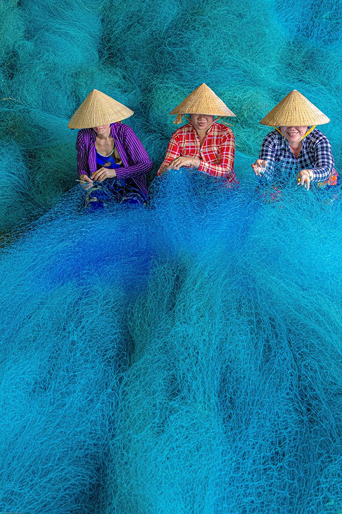 Vietnam-Women repairing fishing nets art print by Tom Norring for $57.95 CAD