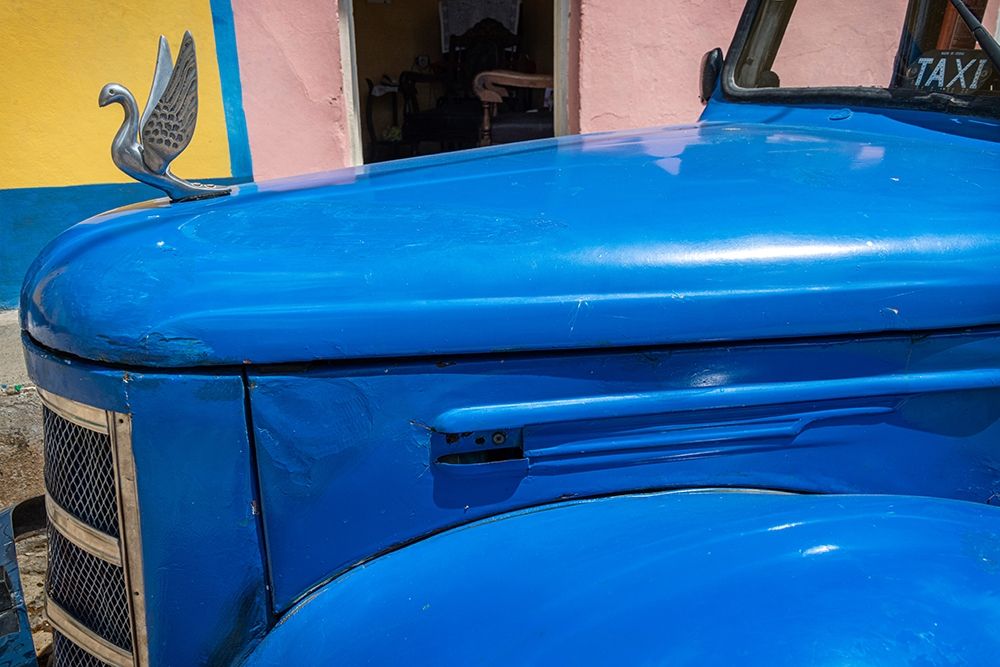 Detail of classic blue American car with chrome swan hood ornament in Trinidad-Cuba art print by Janis Miglavs for $57.95 CAD