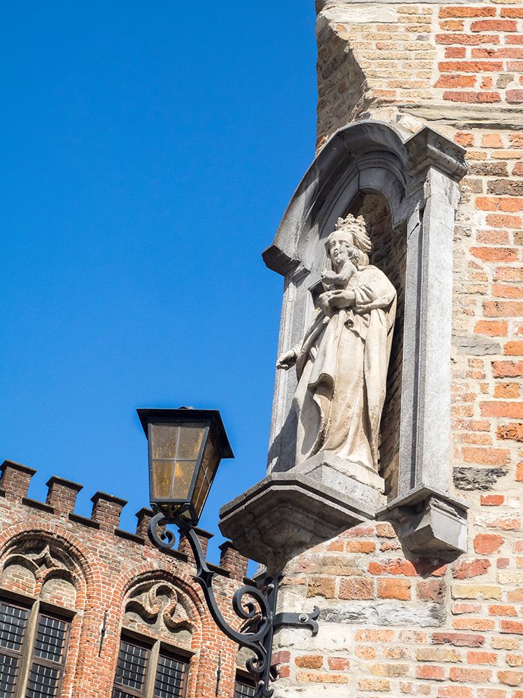 Belgium-Brugge. A stone statue on the cornerstone of a building. art print by Julie Eggers for $57.95 CAD