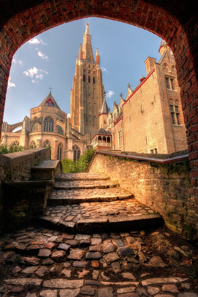 An arch leads to a church in Bruges-Belgium art print by Steve Mohlenkamp for $57.95 CAD