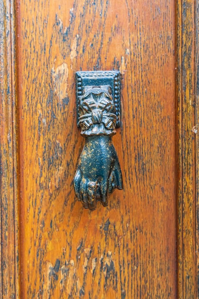 France-Dordogne-Hautefort A metal door knocker in the shape of a hand in the town of Hautefort art print by Emily Wilson for $57.95 CAD