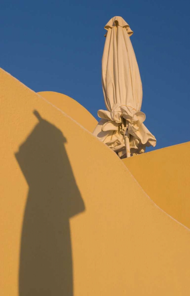 Greece, Santorini Sun umbrella against a wall art print by Bill Young for $57.95 CAD