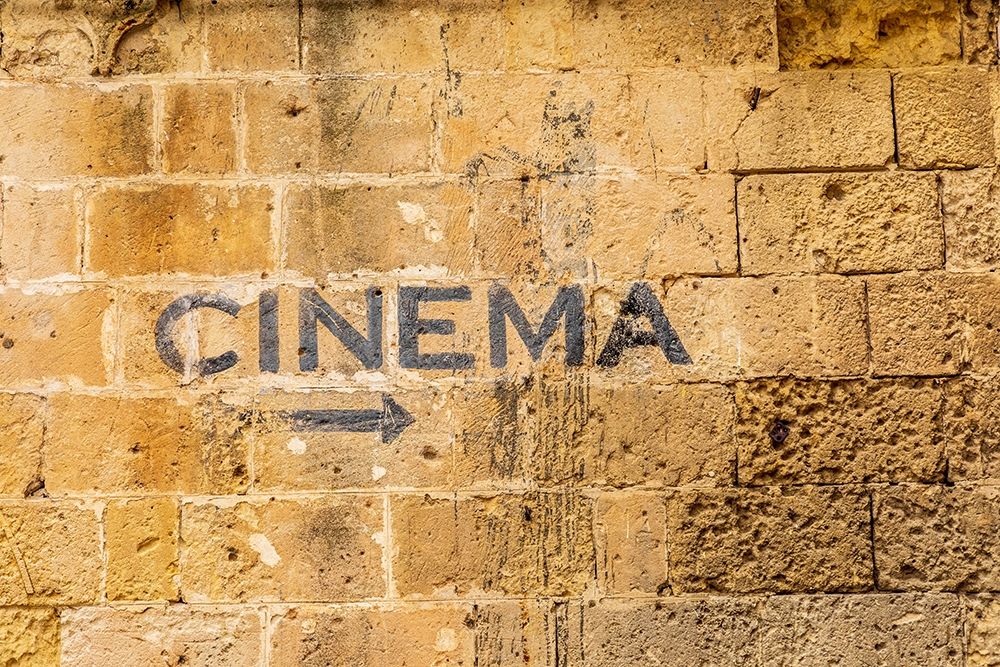 Italy-Basilicata-Province of Matera-Matera Sign on a wall pointing to a cinema-movie theater art print by Emily Wilson for $57.95 CAD