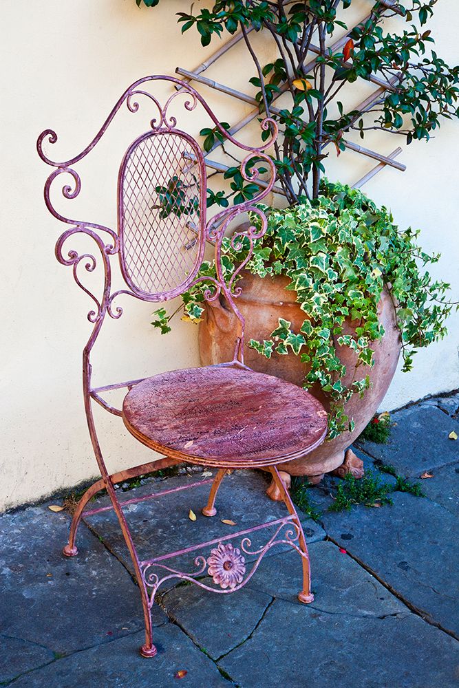 Italy-Tuscany-Lucca Decorative chair and potted plant outside a shop Piazza dellAnfiteatro Romano art print by Julie Eggers for $57.95 CAD