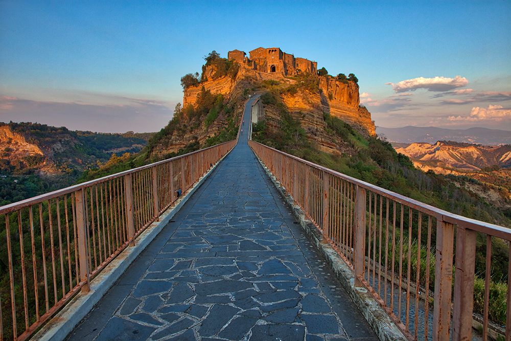 Italy- Tuscany. Evening light of Civita di Bagnoregio and the long bridge leading to town. art print by Julie Eggers for $57.95 CAD