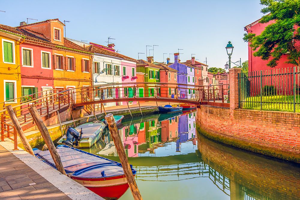Burano, Lagoon of Venice, Italy. Colorful houses and boats in town on this small island in lagoon. art print by Murray McCallum for $57.95 CAD