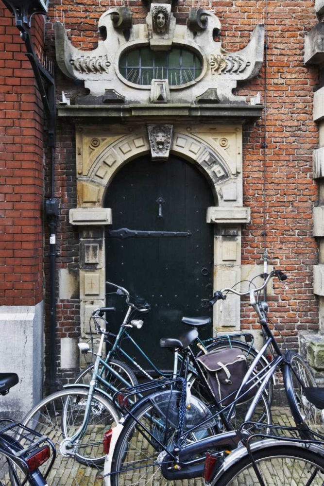 Netherlands, Amsterdam Bicycles by building door art print by Dennis Flaherty for $57.95 CAD