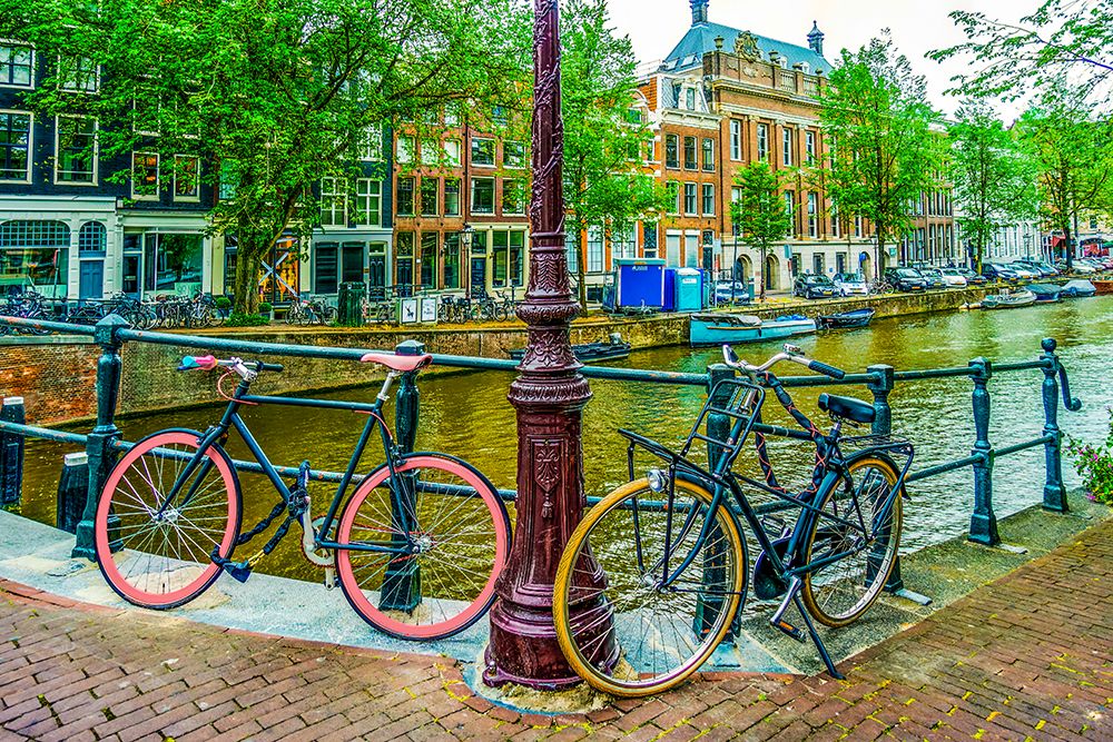 Amsterdam, Netherlands. boat lined canal, historic canal tall houses and bicycles. art print by Murray McCallum for $57.95 CAD