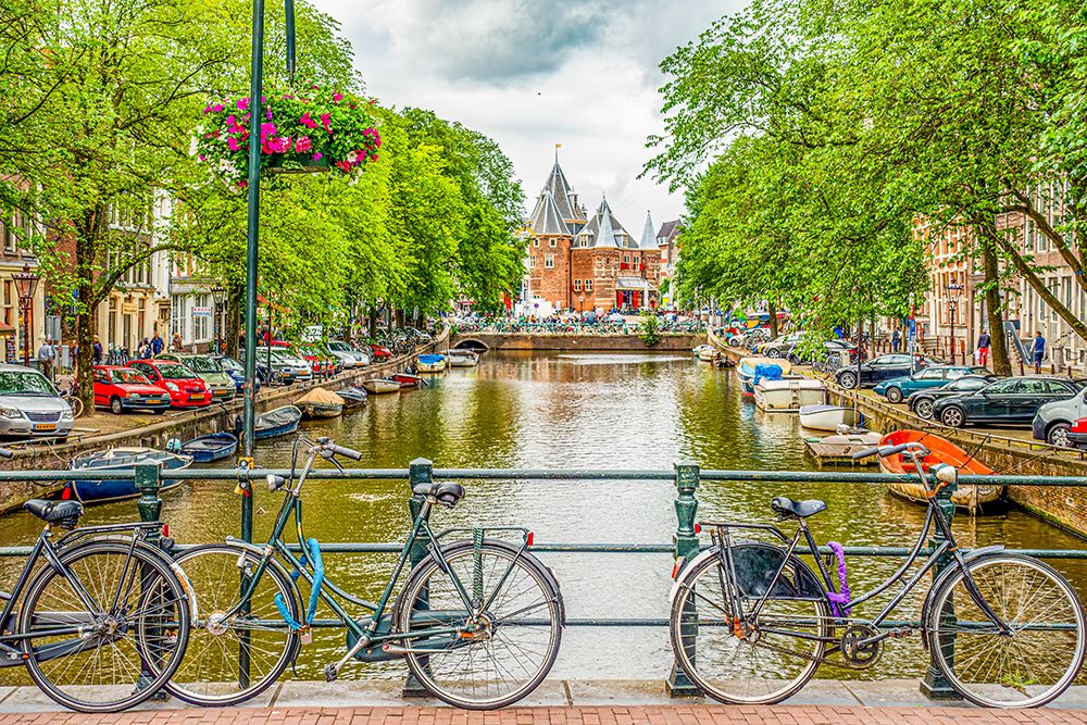 Amsterdam, Netherlands. bicycles chained to a bridge overlooking a canal. art print by Murray McCallum for $57.95 CAD