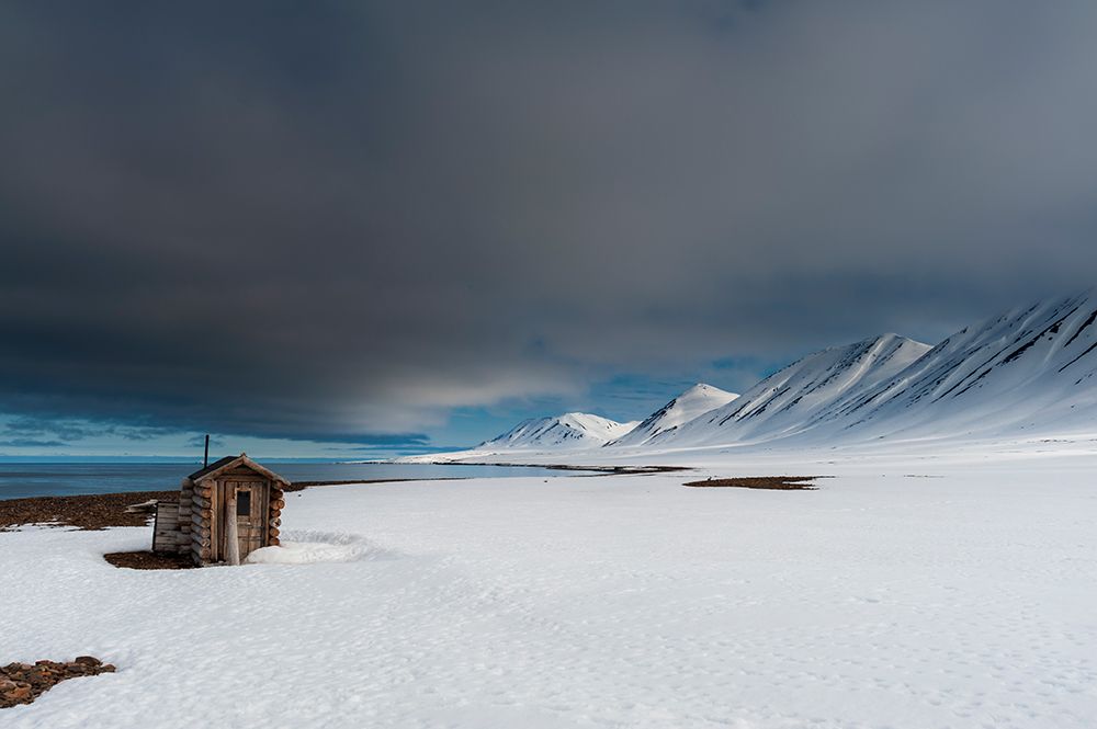 A log cabin on the snow covered beach at Mushamna-Spitsbergen Island-Svalbard-Norway art print by Sergio Pitamitz for $57.95 CAD
