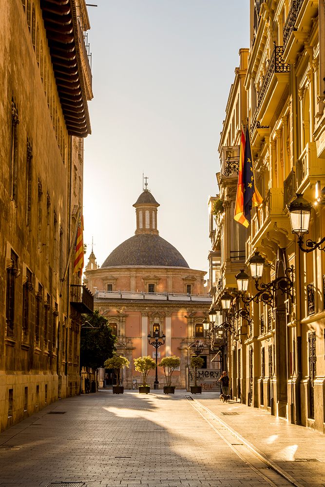 Narrow cobblestone street and Cathedral Dome near Placa de la Mare de Deu, Valencia, Spain. art print by Michael DeFreitas for $57.95 CAD