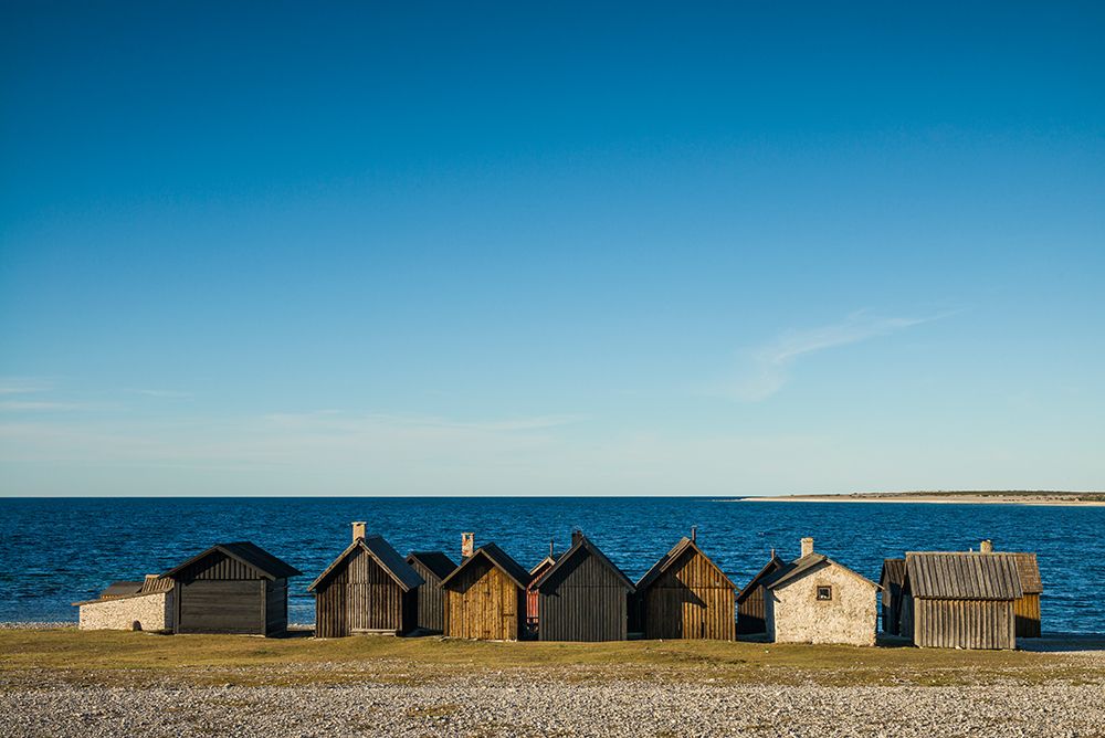 Sweden-Faro Island-Kursviken-coastal farmers fishing shacks-sunset art print by Walter Bibikow for $57.95 CAD