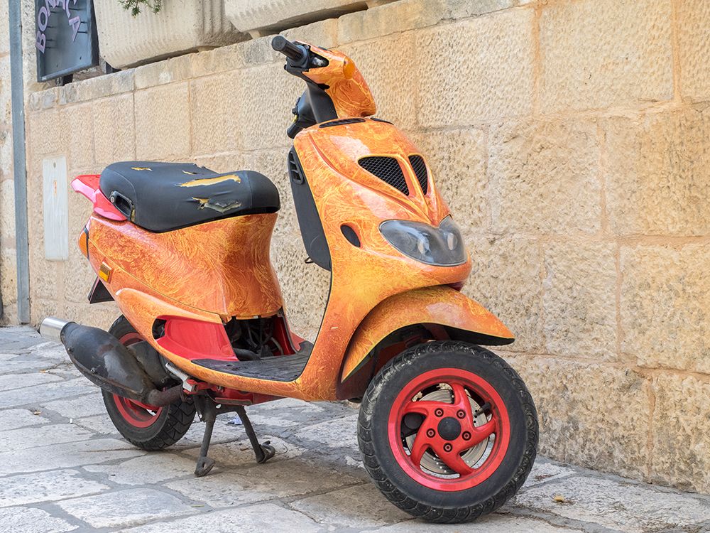 Croatia-Hvar. Bright orange vespa bike in the town of Hvar. (Editorial Use Only) art print by Julie Eggers for $57.95 CAD