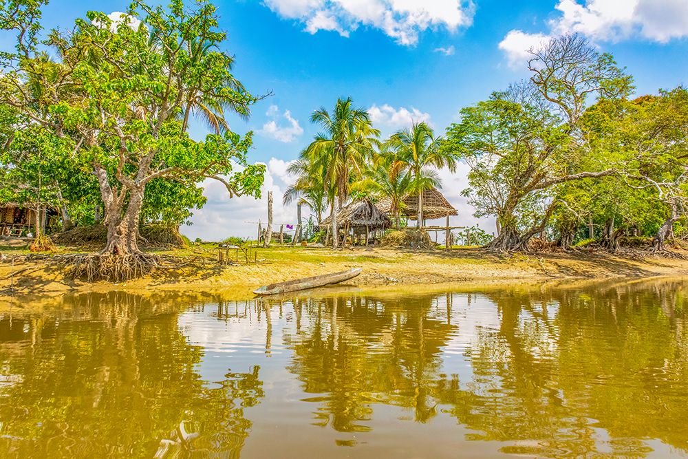 Sepik River, Papua New Guinea. Homestead and sandy banks reflected along the river. art print by Murray McCallum for $57.95 CAD