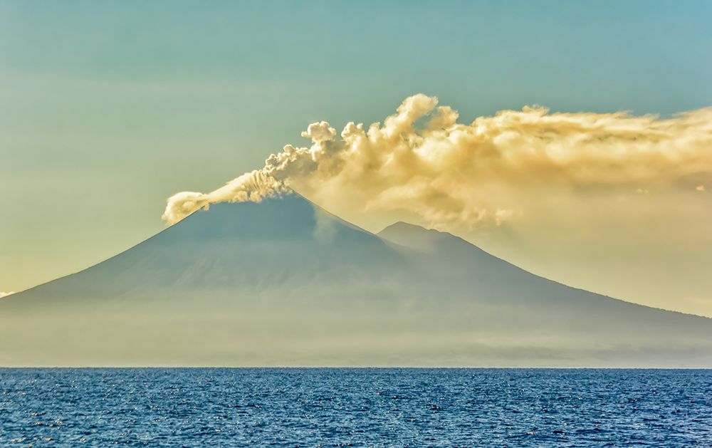 Active Volcano, Coral Sea, Papua New Guinea. Active volcano puffing smoke at sunrise. art print by Murray McCallum for $57.95 CAD