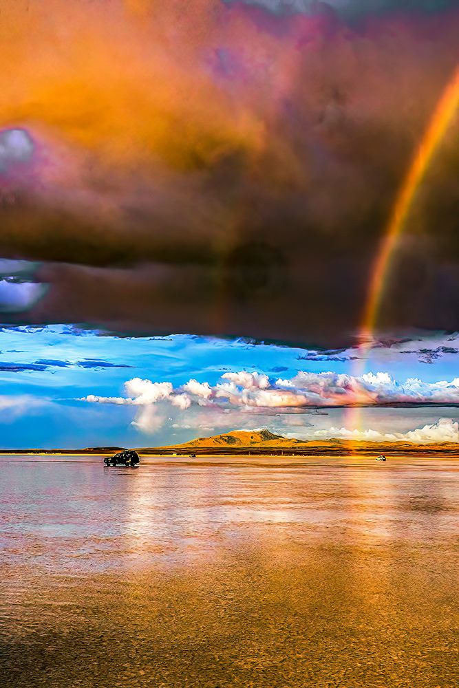 Salar de Uyuni, Bolivia. Rainbow appearing at sunset over the worlds largest salt flat. art print by Murray McCallum for $57.95 CAD