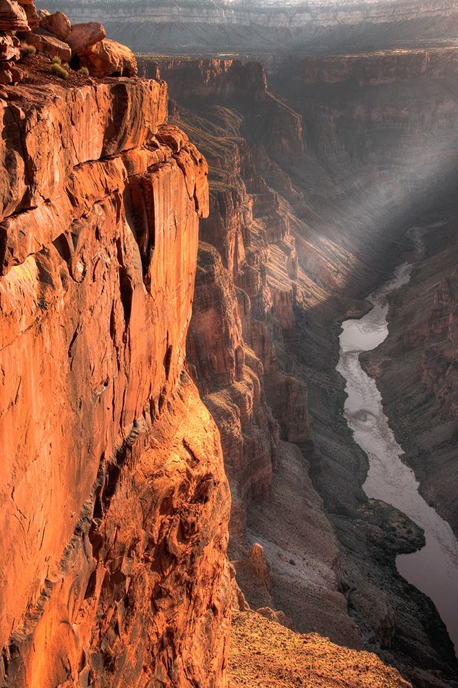 A lone ray of light filters through the clouds at sunrise at Toroweap Overlook in the grand canyon art print by Steve Mohlenkamp for $57.95 CAD