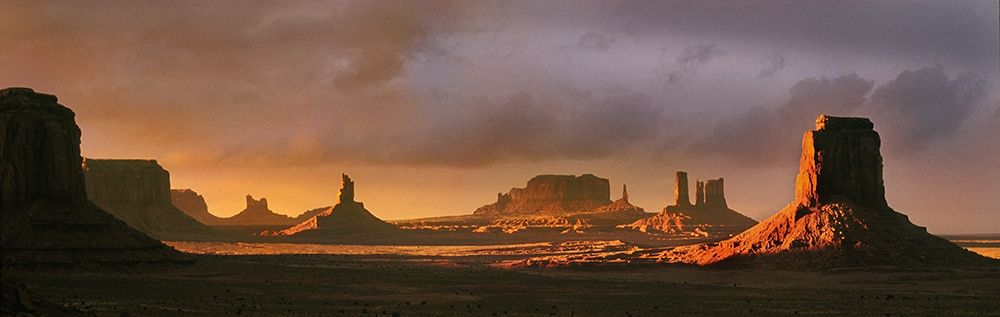 Last light bathes Monument Valley in deep oranges and lavenders on the Arizona-Utah border art print by Steve Mohlenkamp for $57.95 CAD