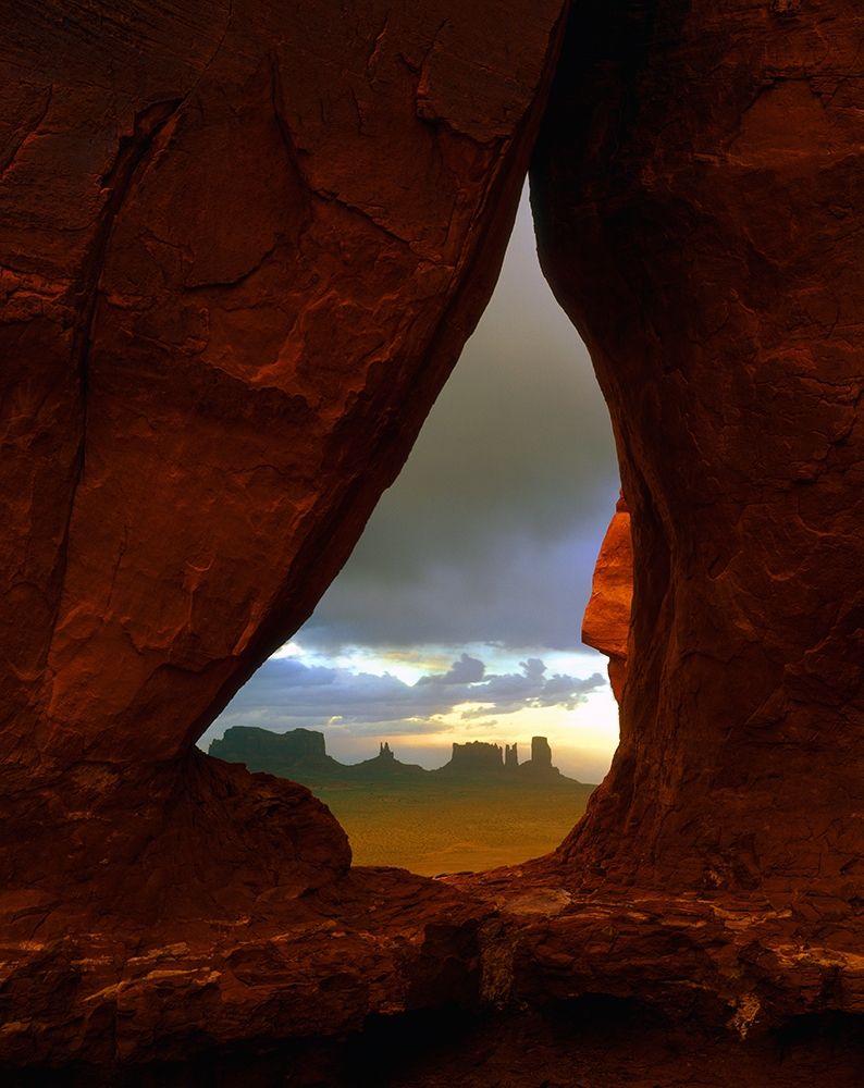Teardrop arch frames the Monument Valley rock formations on the Utah-Arizona border art print by Steve Mohlenkamp for $57.95 CAD