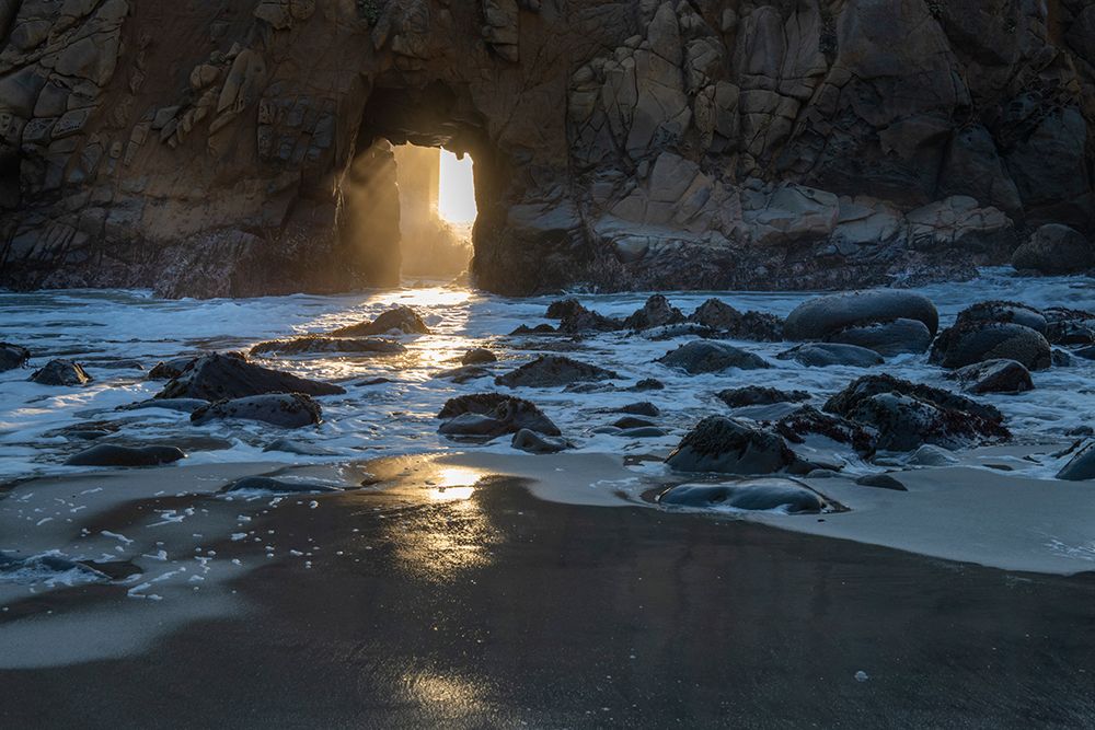 Sun shines through a tunnel in a sea cliff in the Big Sur area. art print by Betty Sederquist for $57.95 CAD