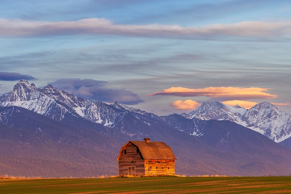 Rustic old barn in evening light with Mission Mountains in Pablo-Montana-USA art print by Chuck Haney for $57.95 CAD