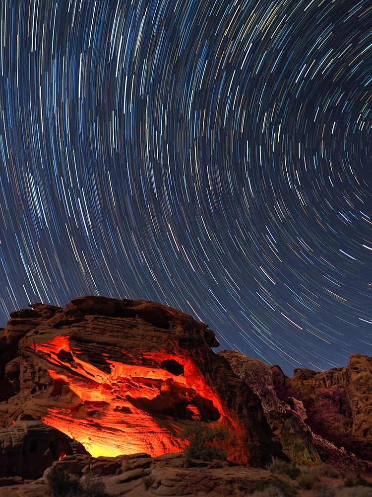 Usa-Nevada. Valley of Fire State Park-star trails and campfire glowing in sandstone rocks art print by Merrill Images for $57.95 CAD