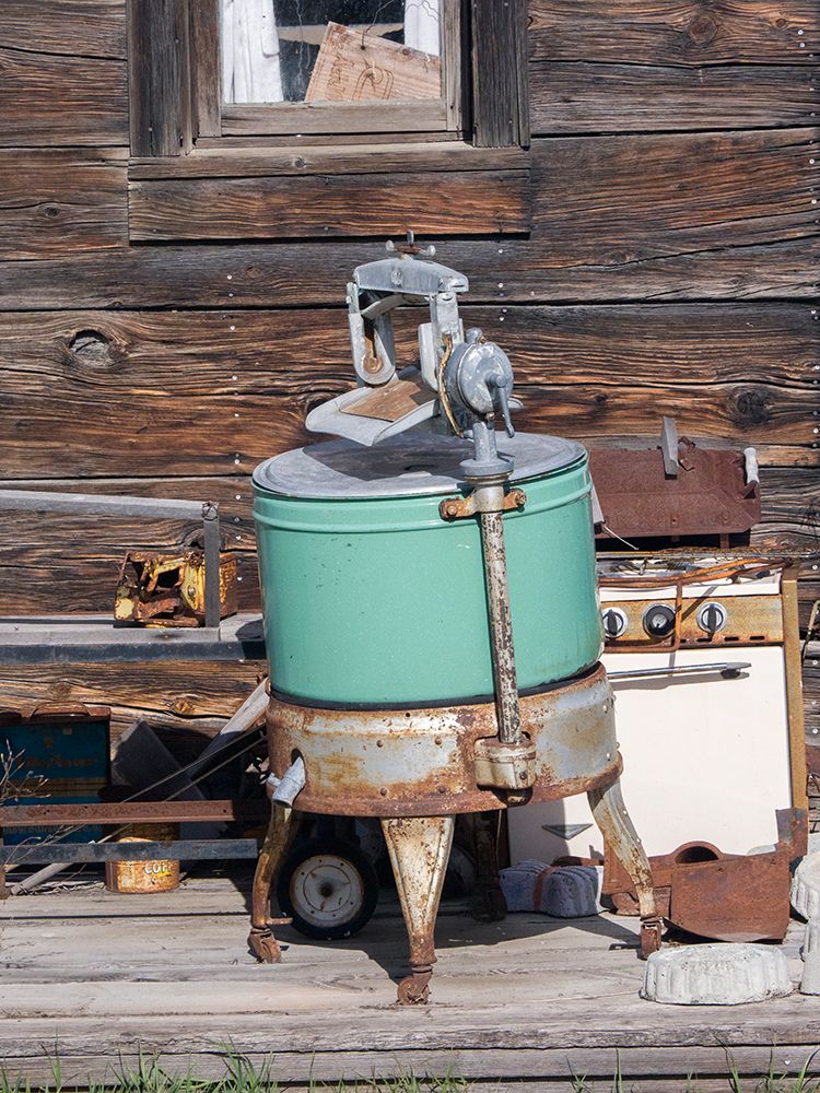 An old washing machine and old rusty stove on the porch of a building in ghost town. art print by Julie Eggers for $57.95 CAD
