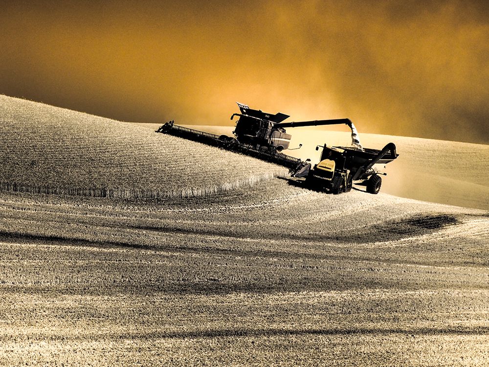 USA, Washington State, Palouse. Infrared combine harvesting on hillside and emptying into loader art print by Terry Eggers for $57.95 CAD