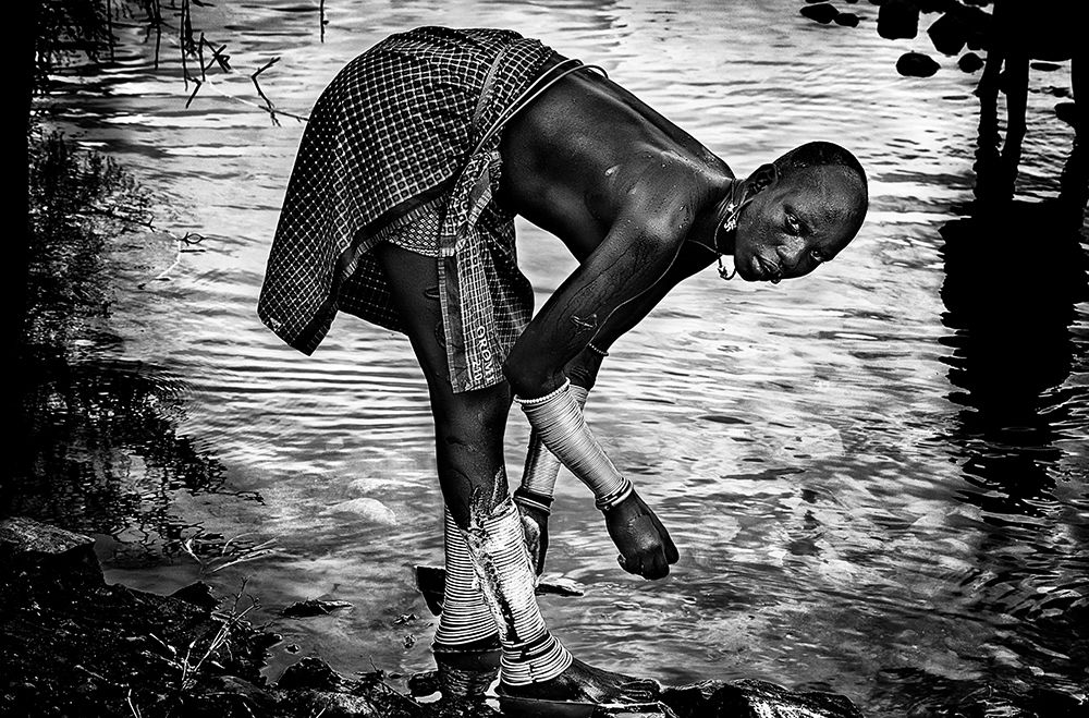 Surma tribe woman washing up her jewelry - Ethiopia art print by Joxe Inazio Kuesta for $57.95 CAD