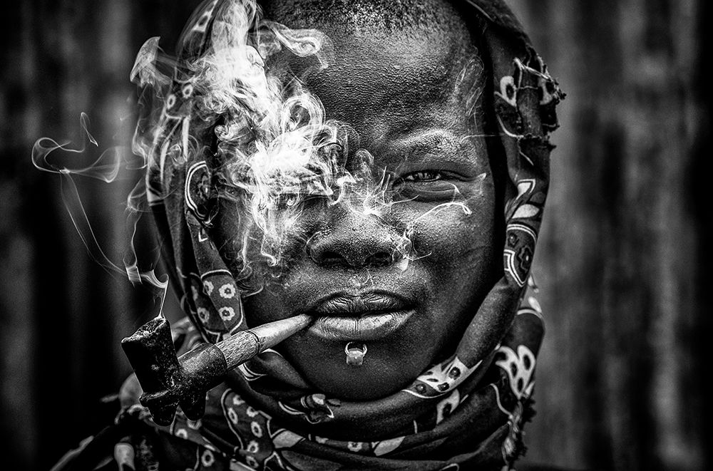Laarim Woman Smoking-South Sudan art print by Joxe Inazio Kuesta for $57.95 CAD