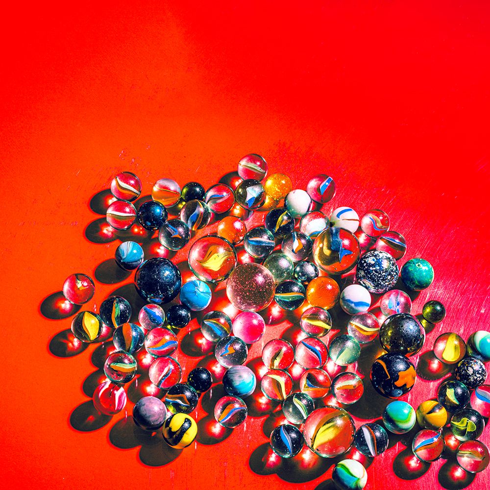 Marbles on vibrant red art print by Julia Ramiro for $57.95 CAD