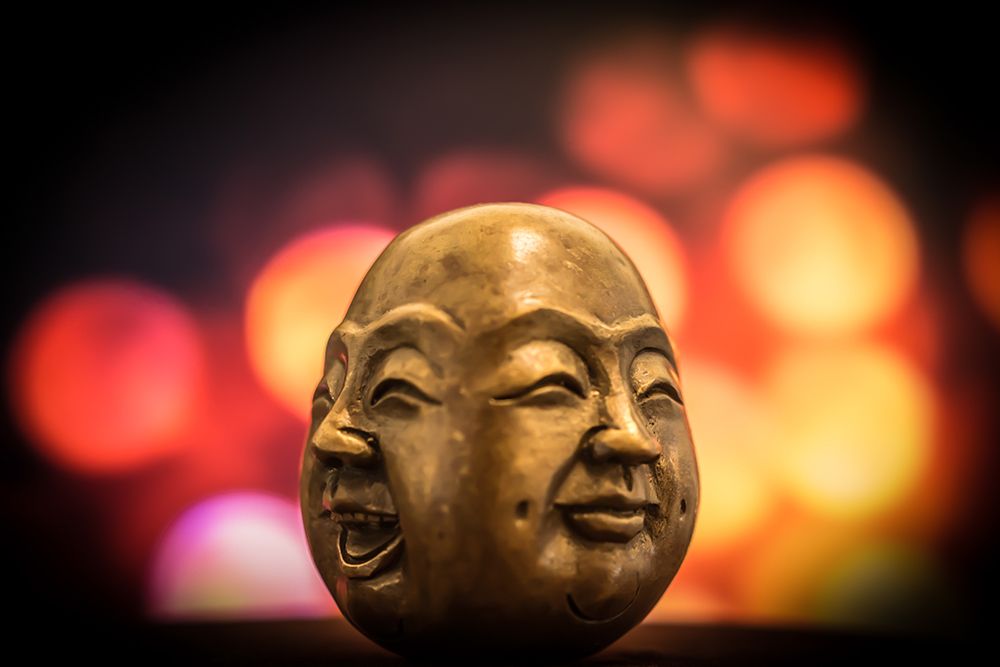 A Brass Figurine Depicting two Smiling Faces of Buddha art print by Artographie for $57.95 CAD