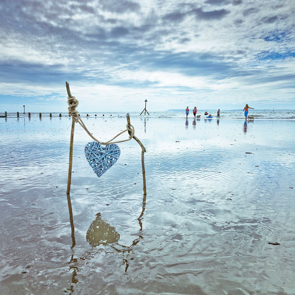 Heart tied up on wooden sticks at the beach art print by Assaf Frank for $57.95 CAD